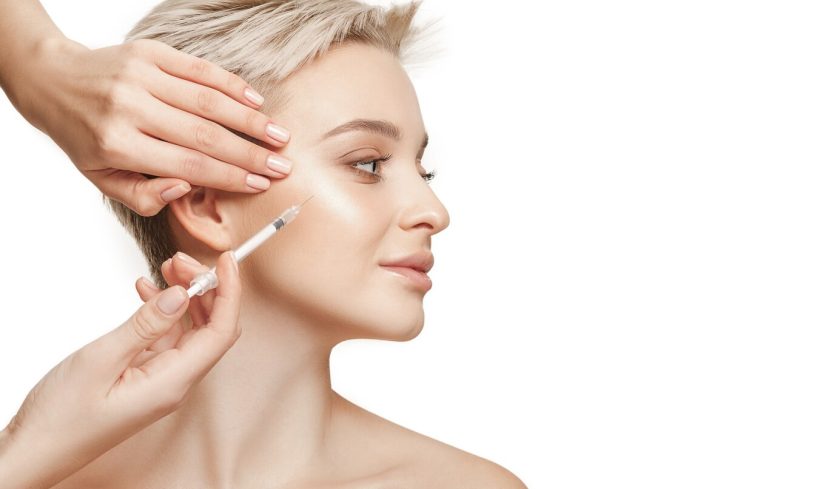 people-lips-cosmetology-plastic-surgery-beauty-concept-beautiful-young-woman-face-hand-with-syringe-making-injection_155003-28149